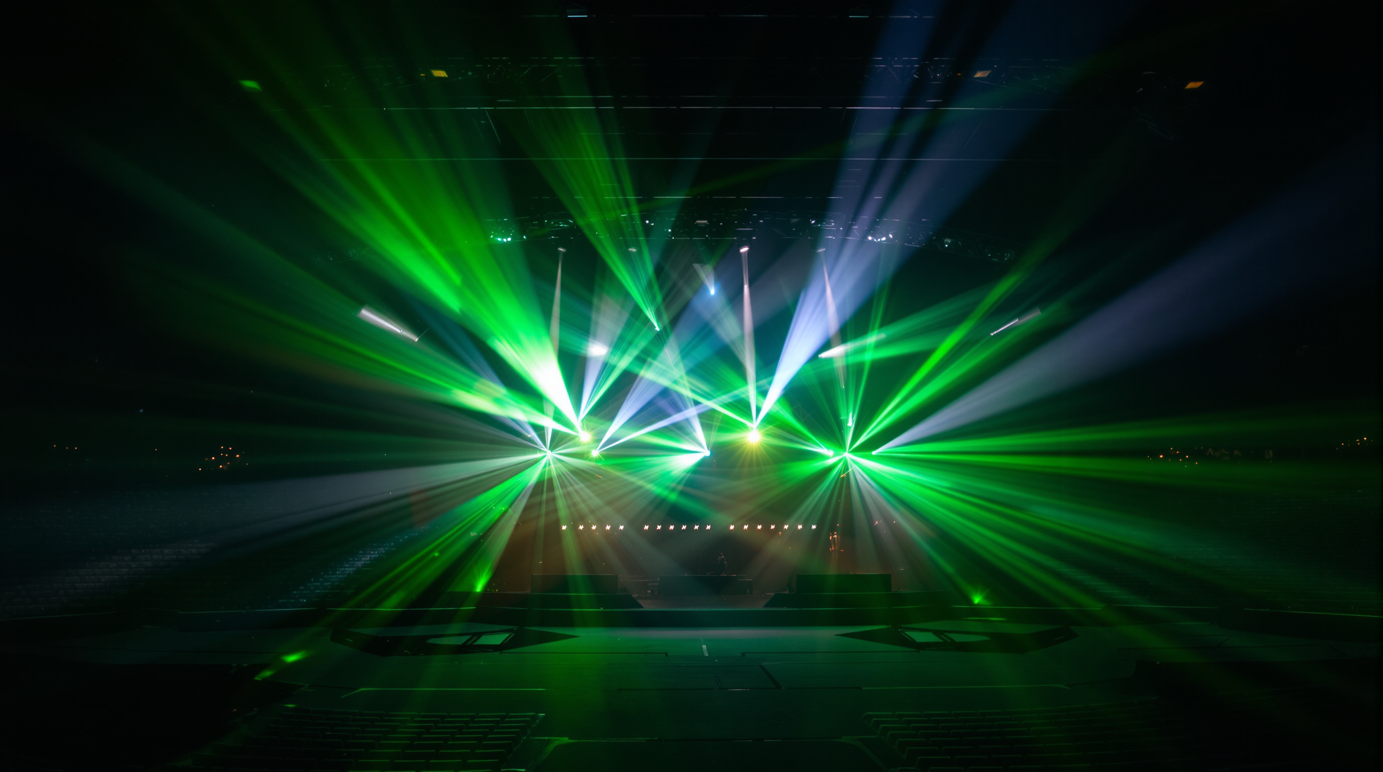 Stage spotlights sweeping across a dark arena